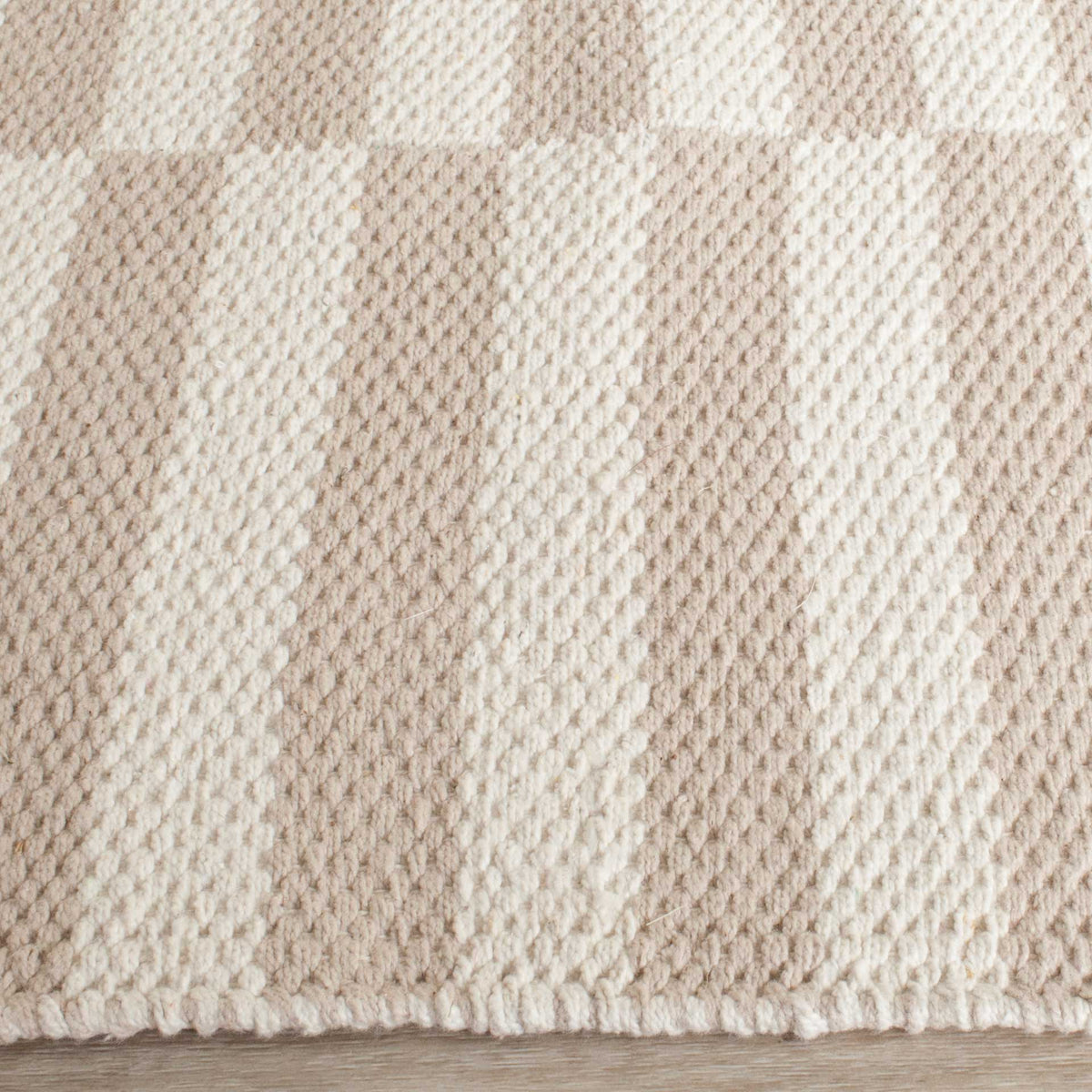 Textured ivory and light gray weaving meets a cleanly finished cotton edge