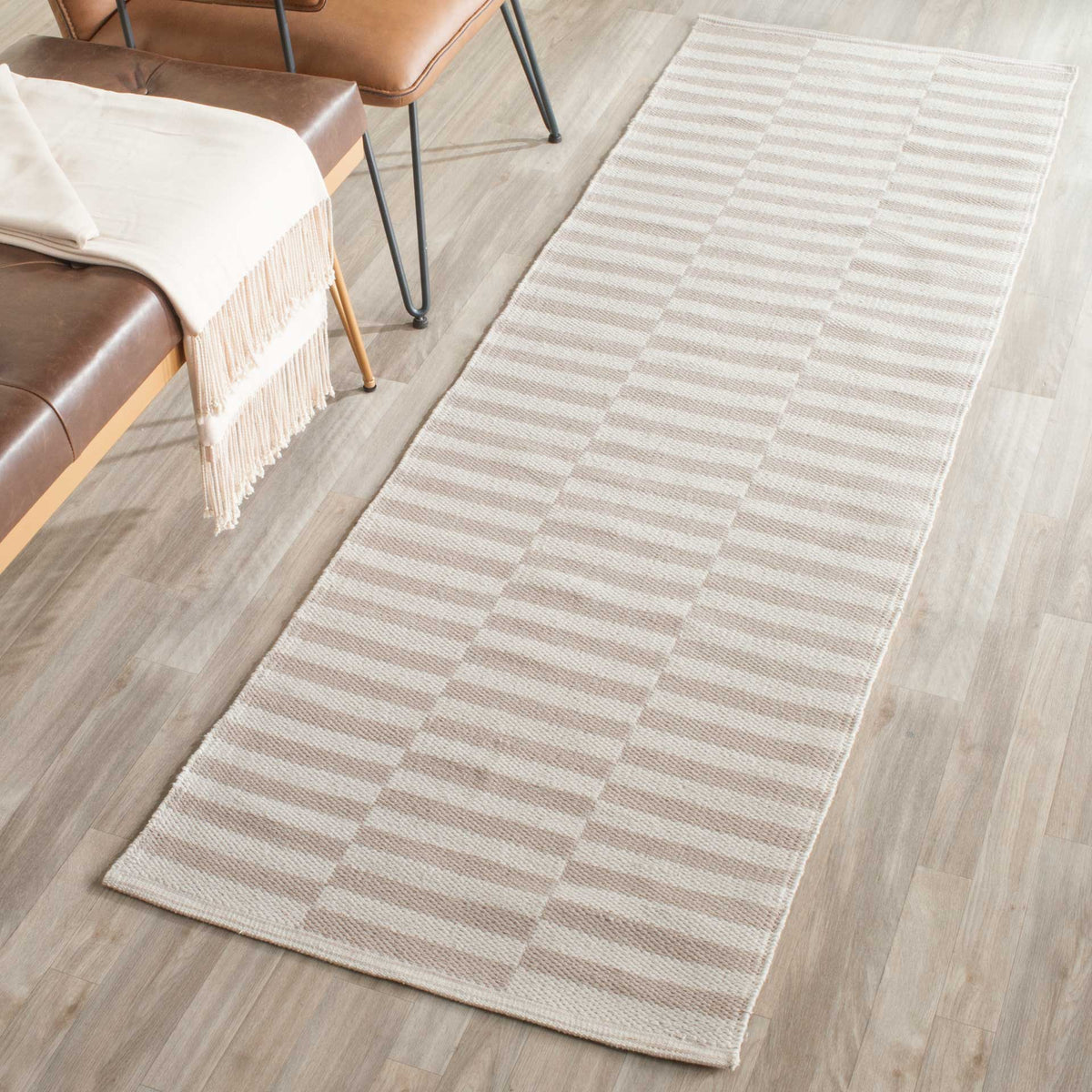 Subtle light gray striping gives this ivory runner a calm, versatile look