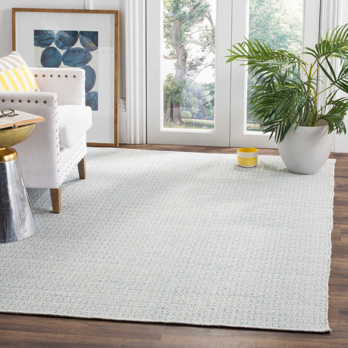 This ivory and light blue rug lends soft color and finely woven pattern to the floor.