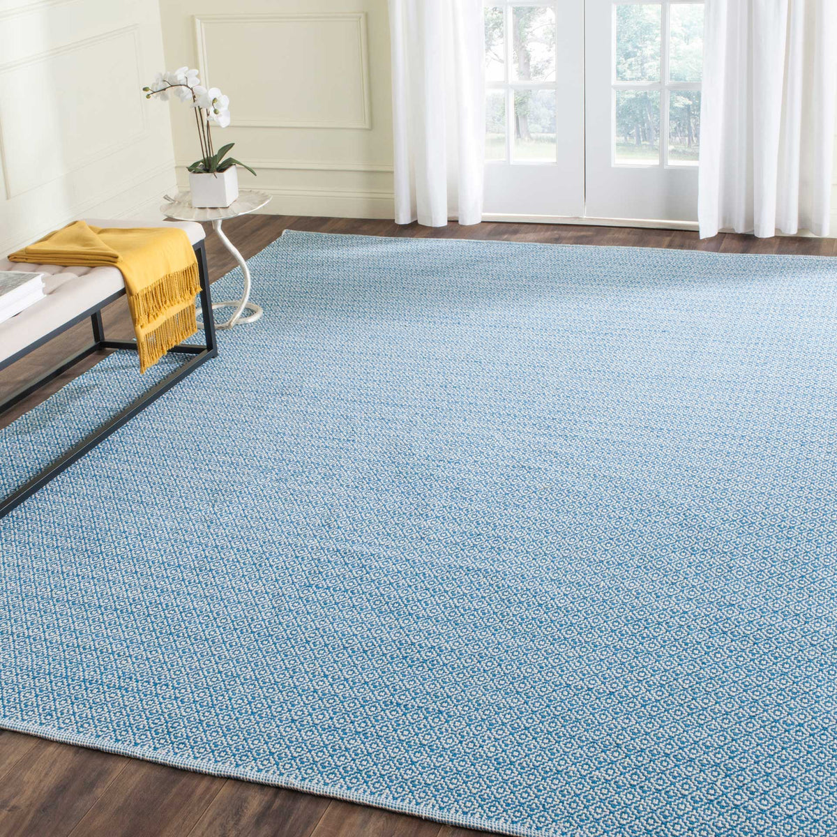 Blue and ivory geometric weaving brings rich pattern and a cool wash of color to the floor.