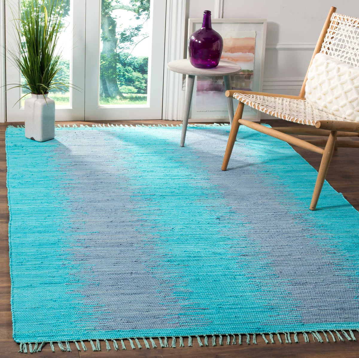 Bright turquoise cotton rug blends smoky gray bands with fringed edges for a fresh, airy feel