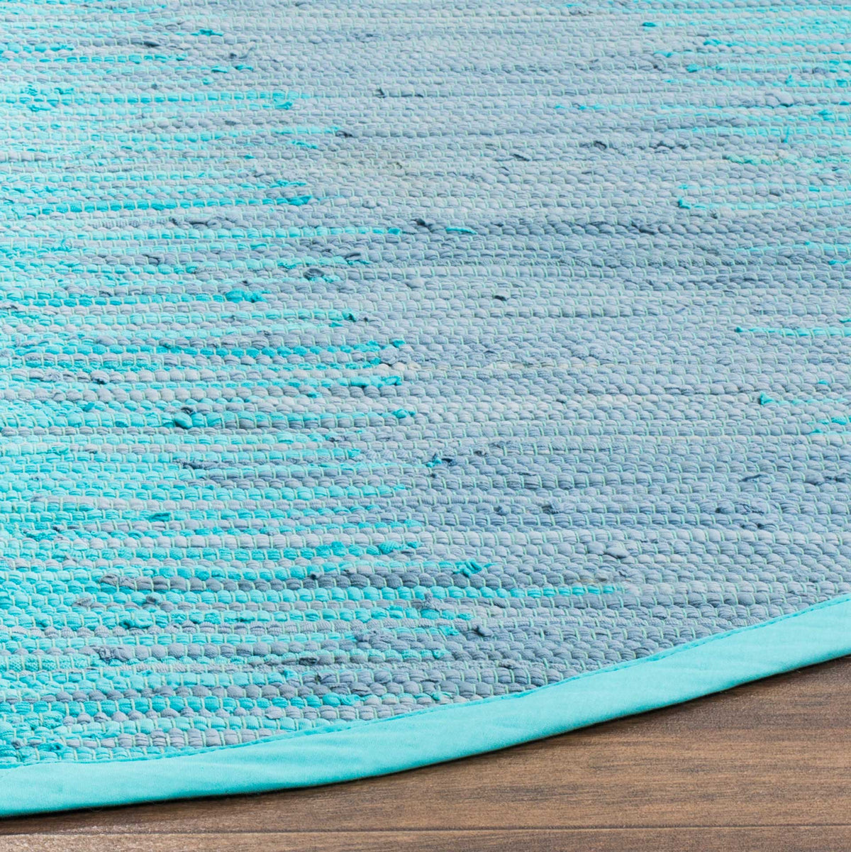 Turquoise and pale gray threads create a nubby weave edged in smooth aqua binding