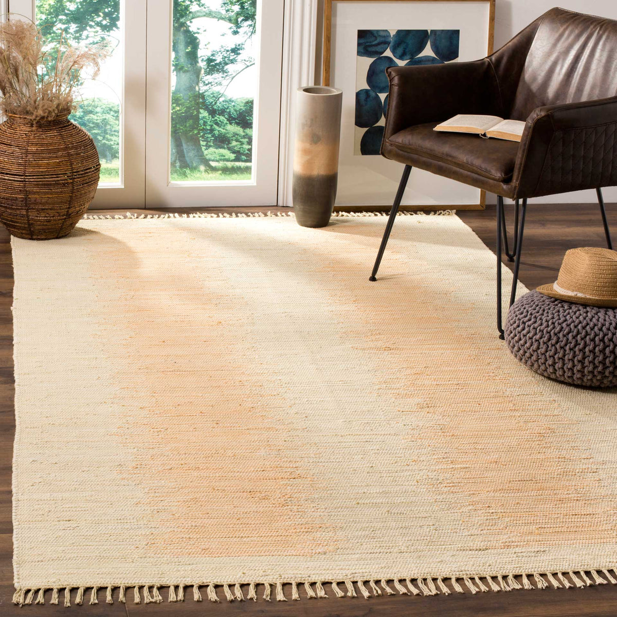 Creamy ivory cotton rug with gentle beige bands and fringe brings airy texture underfoot