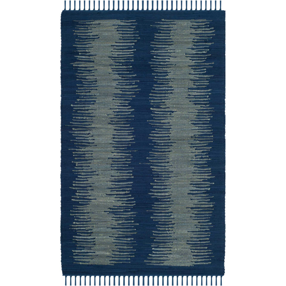 Navy accent rug layers pale blue-gray stripes over a low-profile cotton weave