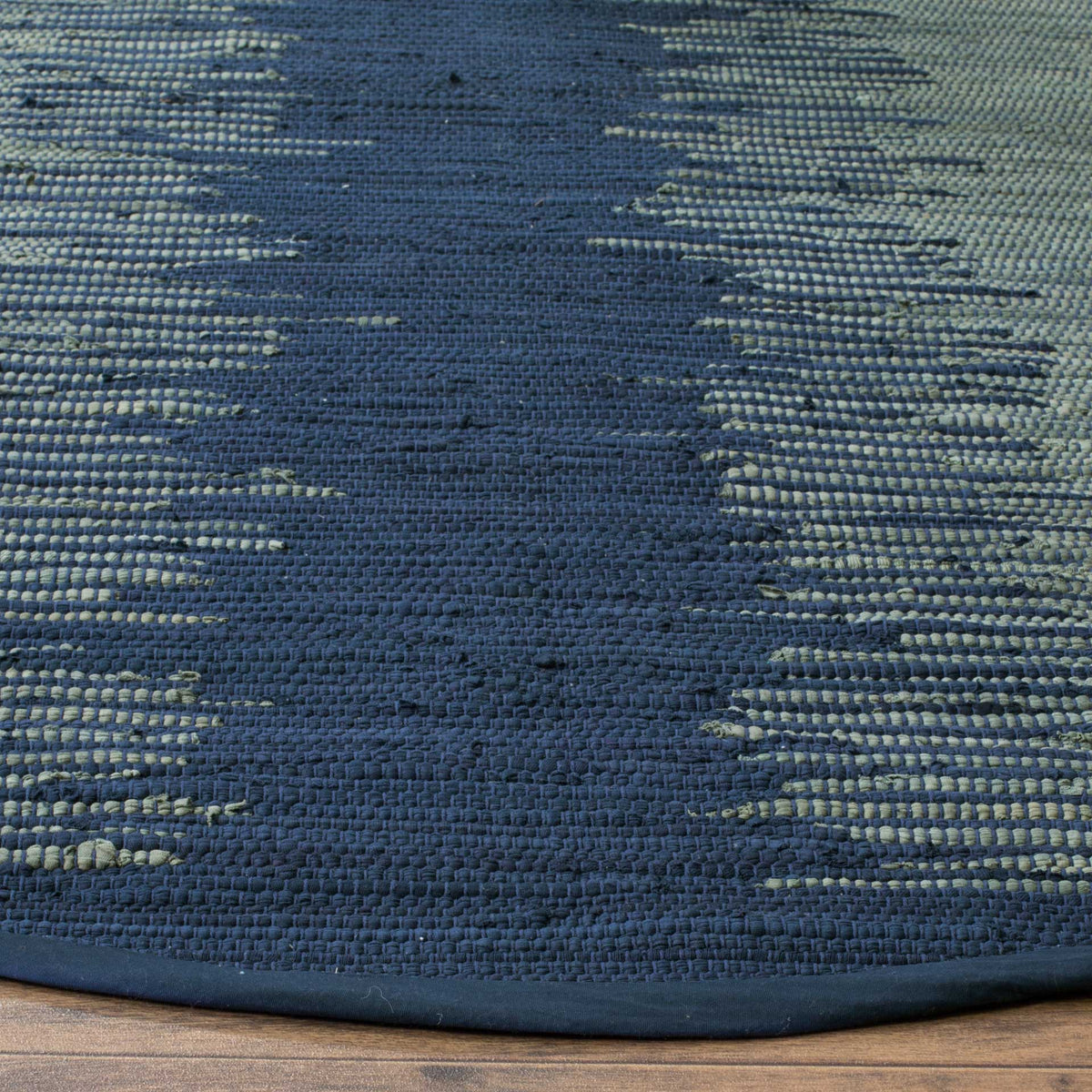 Navy and pale gray threads reveal a tactile cotton weave framed by navy binding