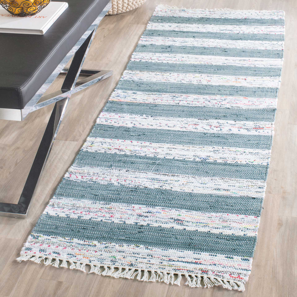 A blue-gray and ivory striped runner brings cozy texture to a wood-floored room.