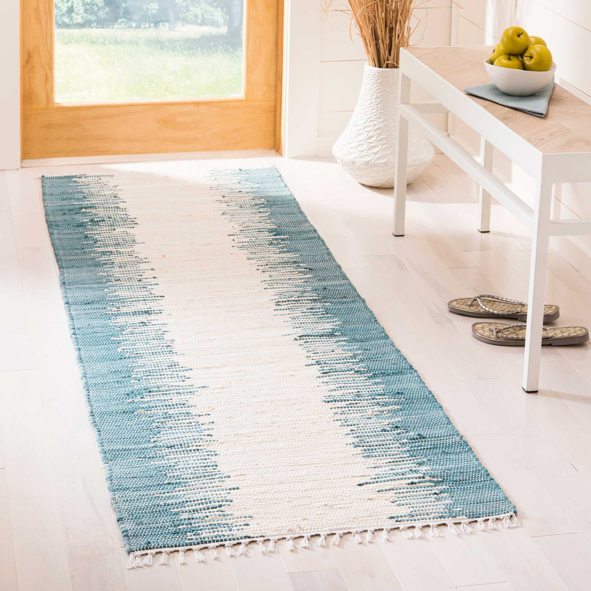 Blue and ivory cotton runner brings a breezy accent to an entryway with its rippling stripes
