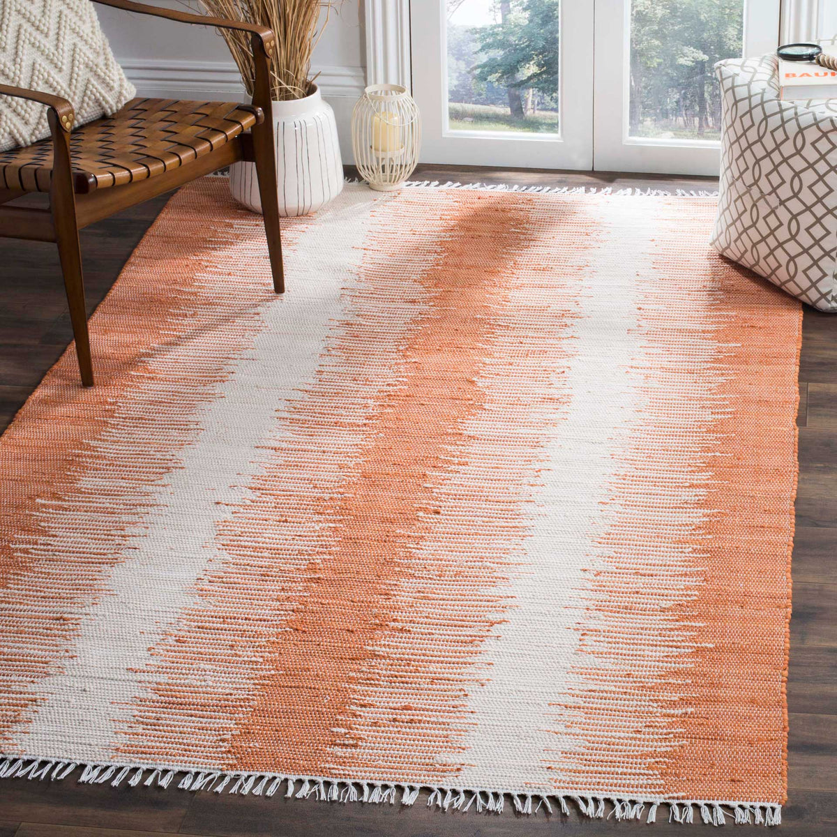Orange and ivory stripes pair with a relaxed fringed border for a bright floor accent.