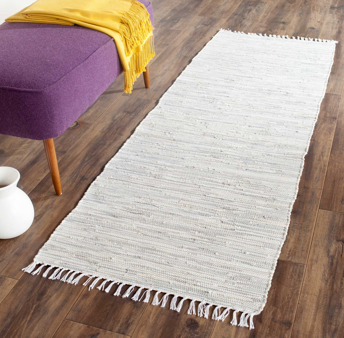 Soft silver runner adds woven texture and a relaxed feel to a wood-floored living space
