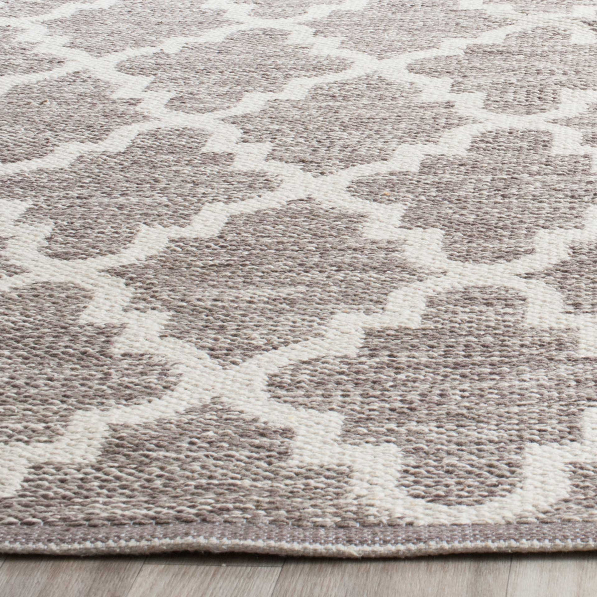 Soft gray cotton yarns mingle with ivory lines in a low-profile, richly woven trellis.