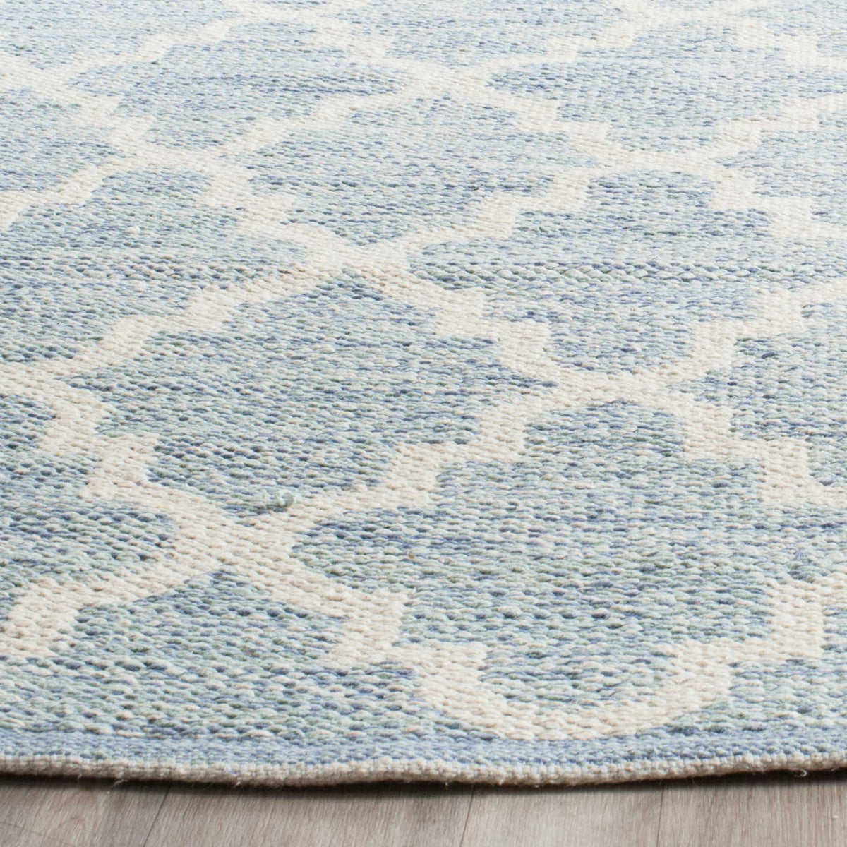 Pale blue woven cotton and ivory curves create a soft, tactile geometric pattern.