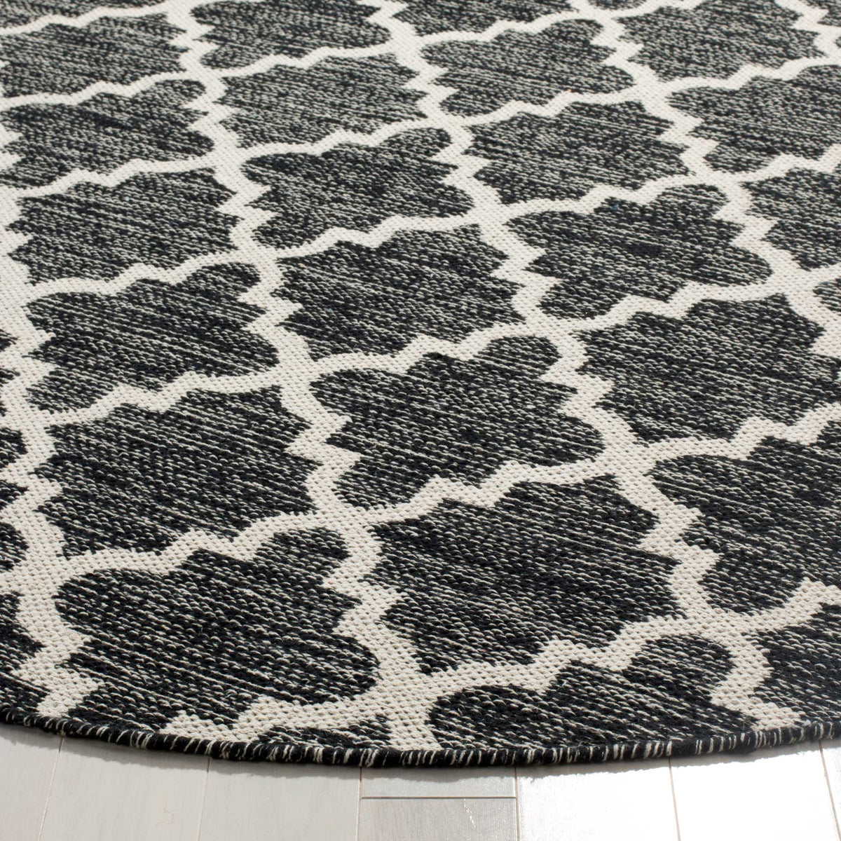 Textured black-and-ivory cotton weave meets a neatly finished curved edge