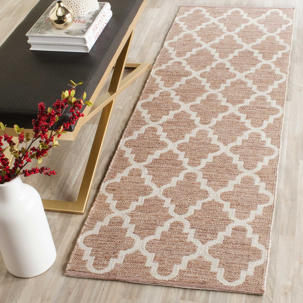 A beige and ivory trellis runner adds soft geometric warmth beside a sleek console table.