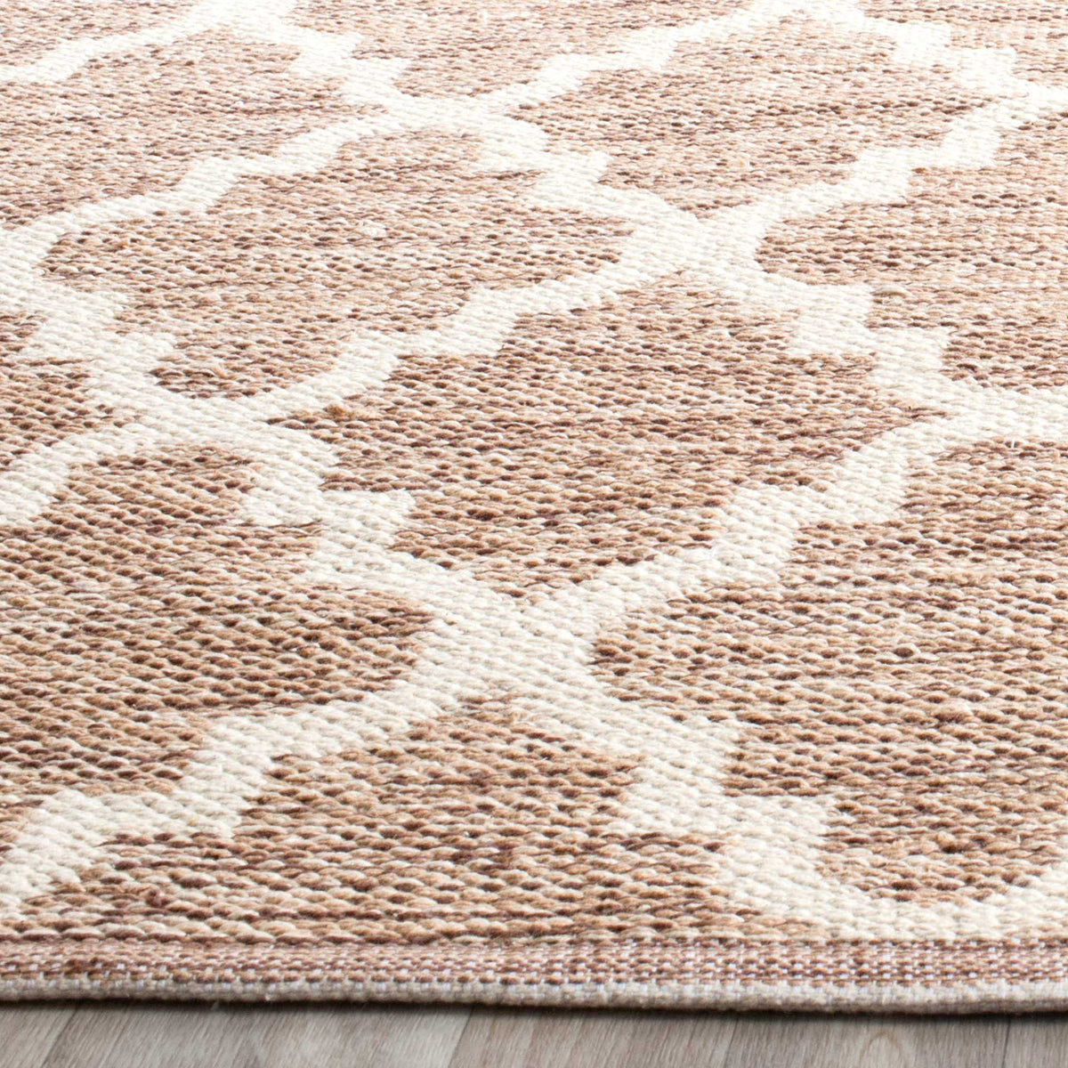 Flecked beige cotton yarns and ivory trellis lines create inviting, touchable texture.
