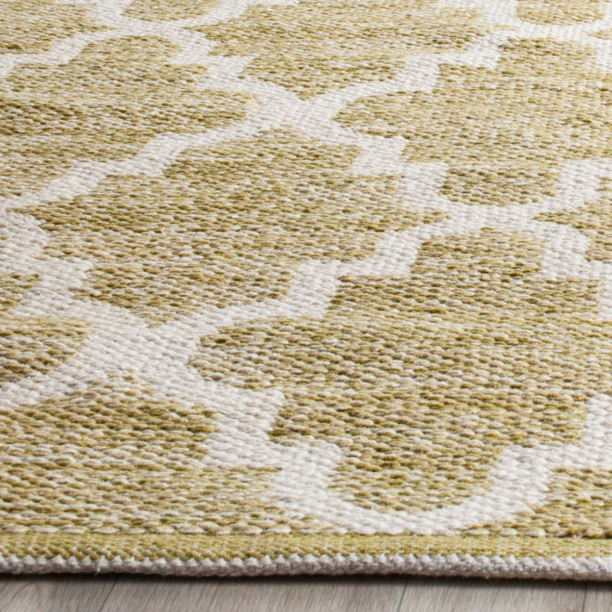 Nubby olive green cotton yarns and ivory outlines give the trellis tactile definition.