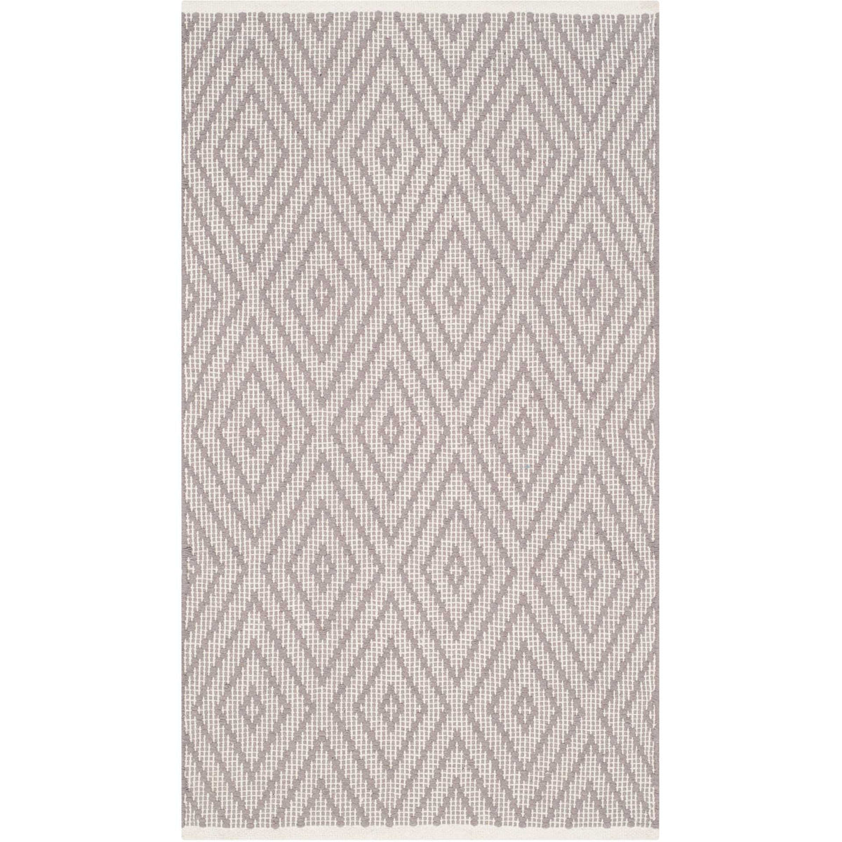 Oversized gray diamond motifs make a striking statement on this small ivory accent rug.