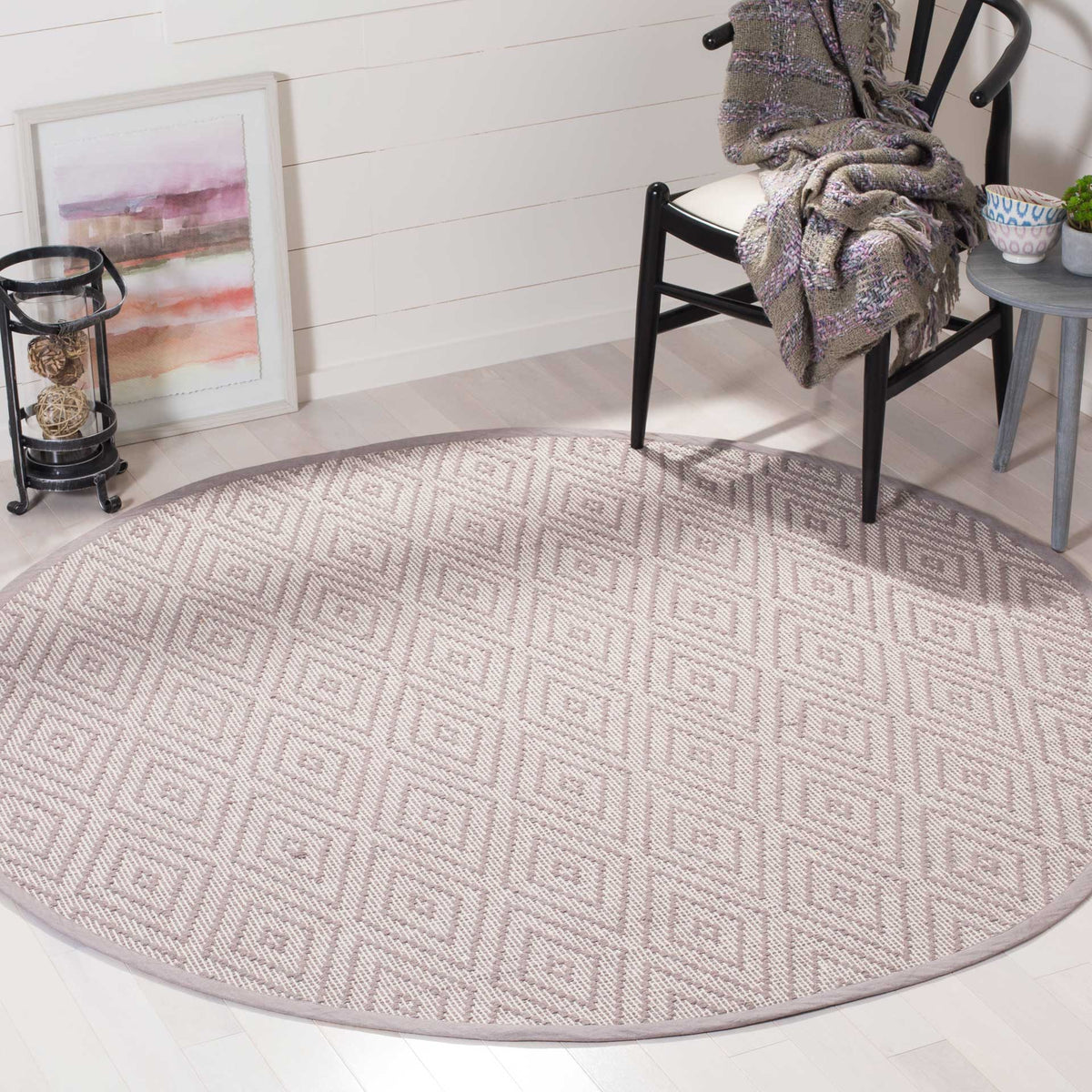 Gray and ivory round rug lends patterned texture to a bright seating area.