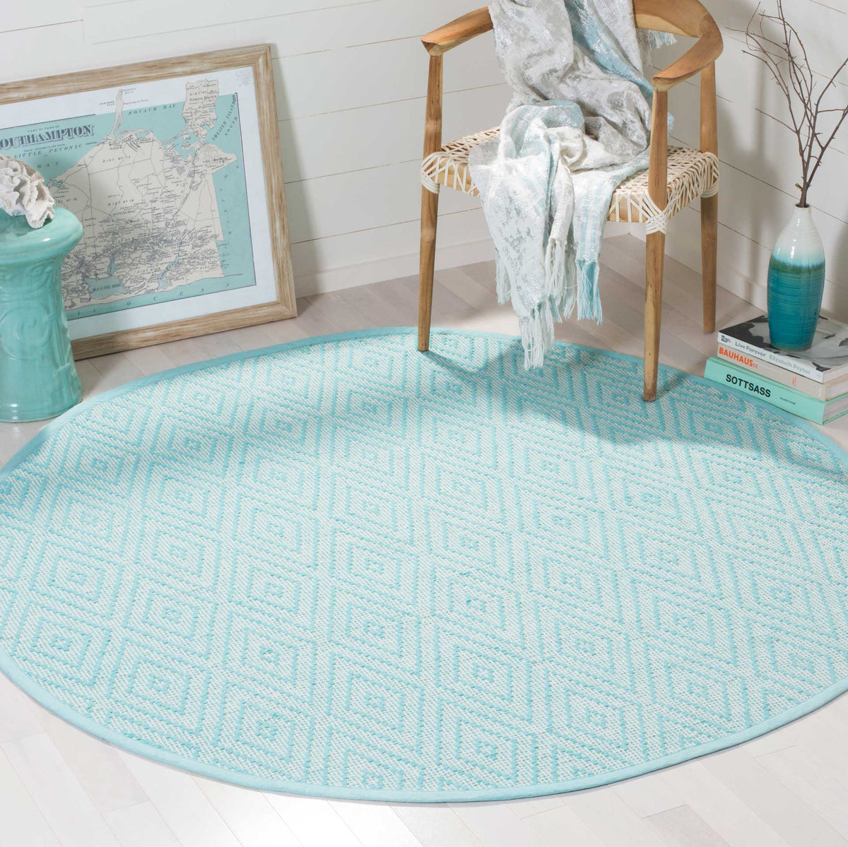 Turquoise and ivory round rug adds a bright geometric accent beneath a chair.