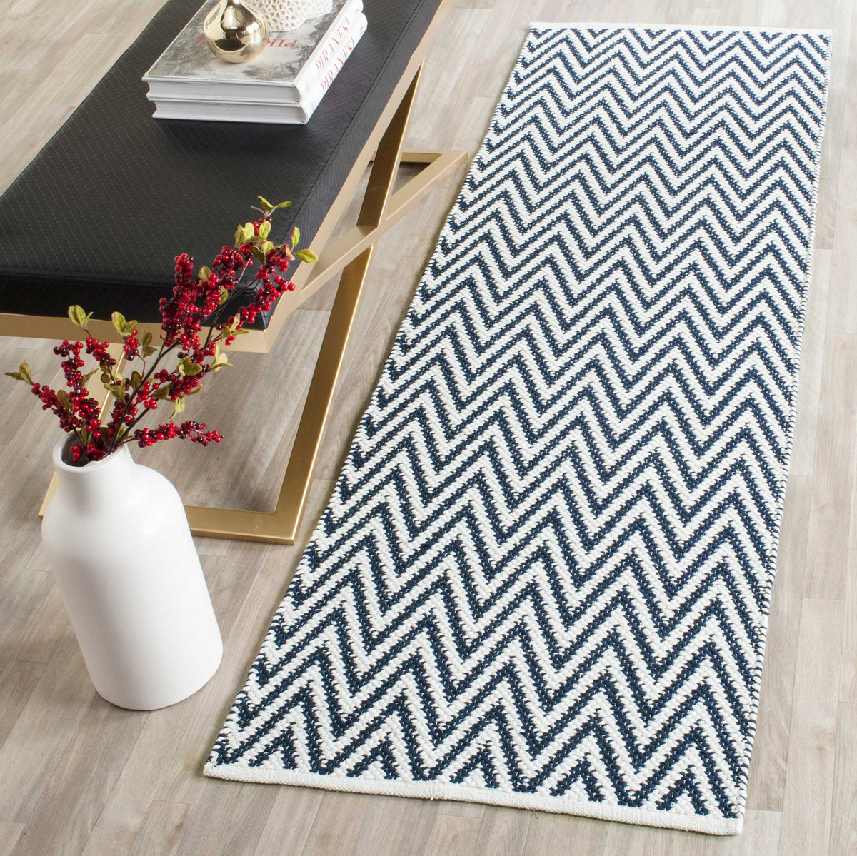 A navy and ivory zigzag runner brings crisp geometry to a pale wood floor.