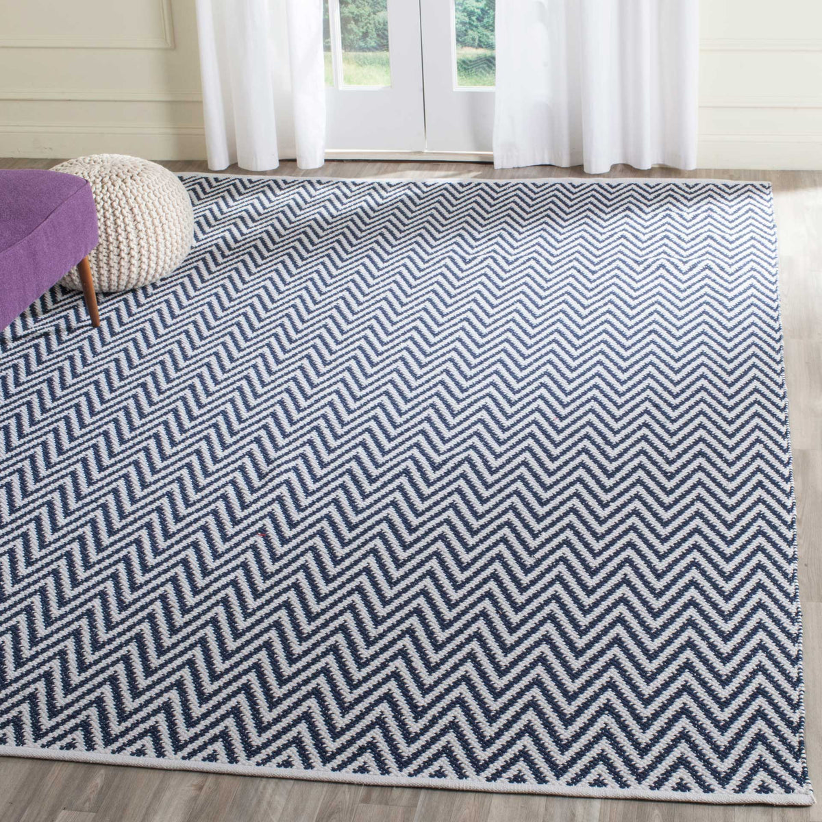 Deep navy chevrons create rhythmic contrast against an ivory ground.