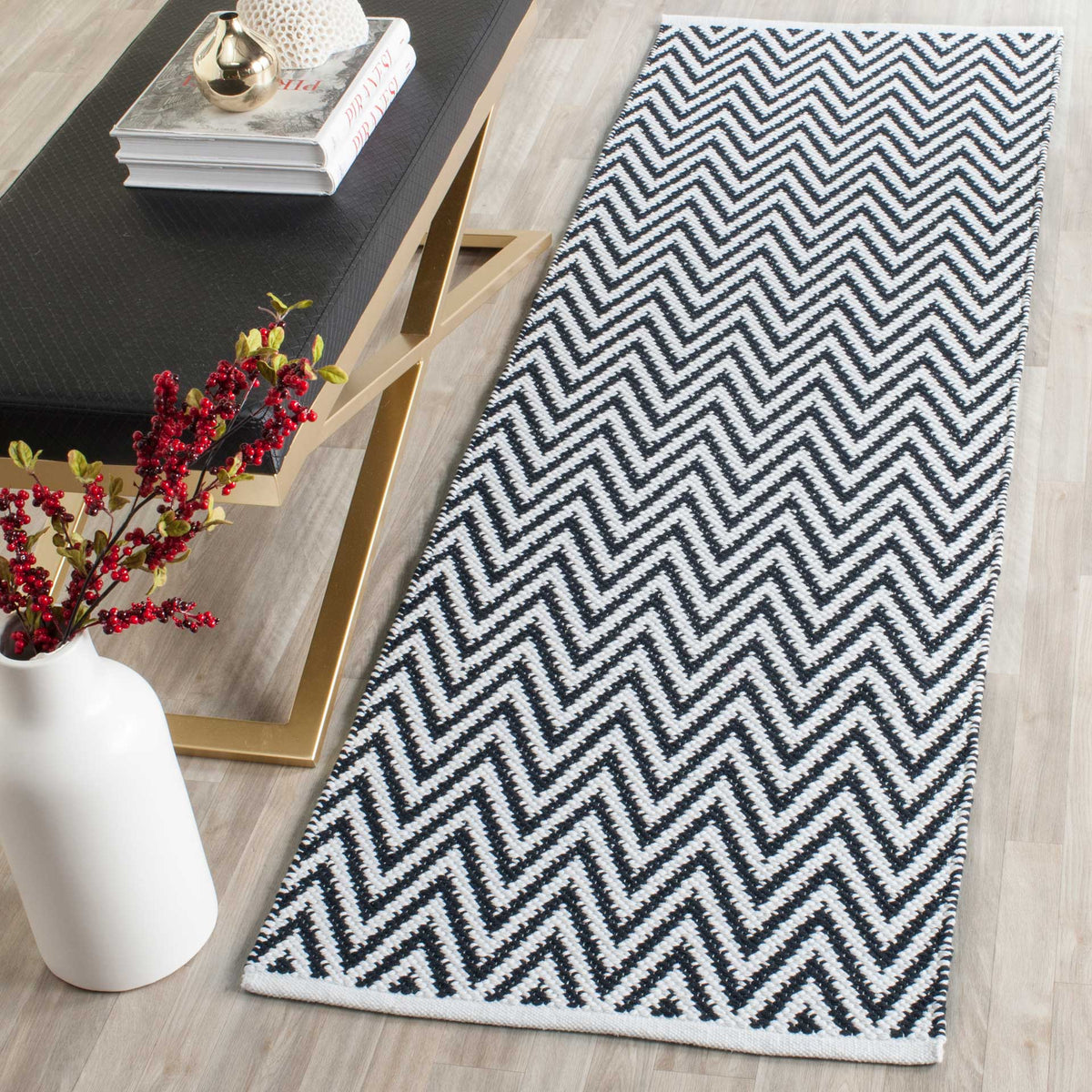 Bold black and ivory zigzags add crisp contrast beside modern furnishings.