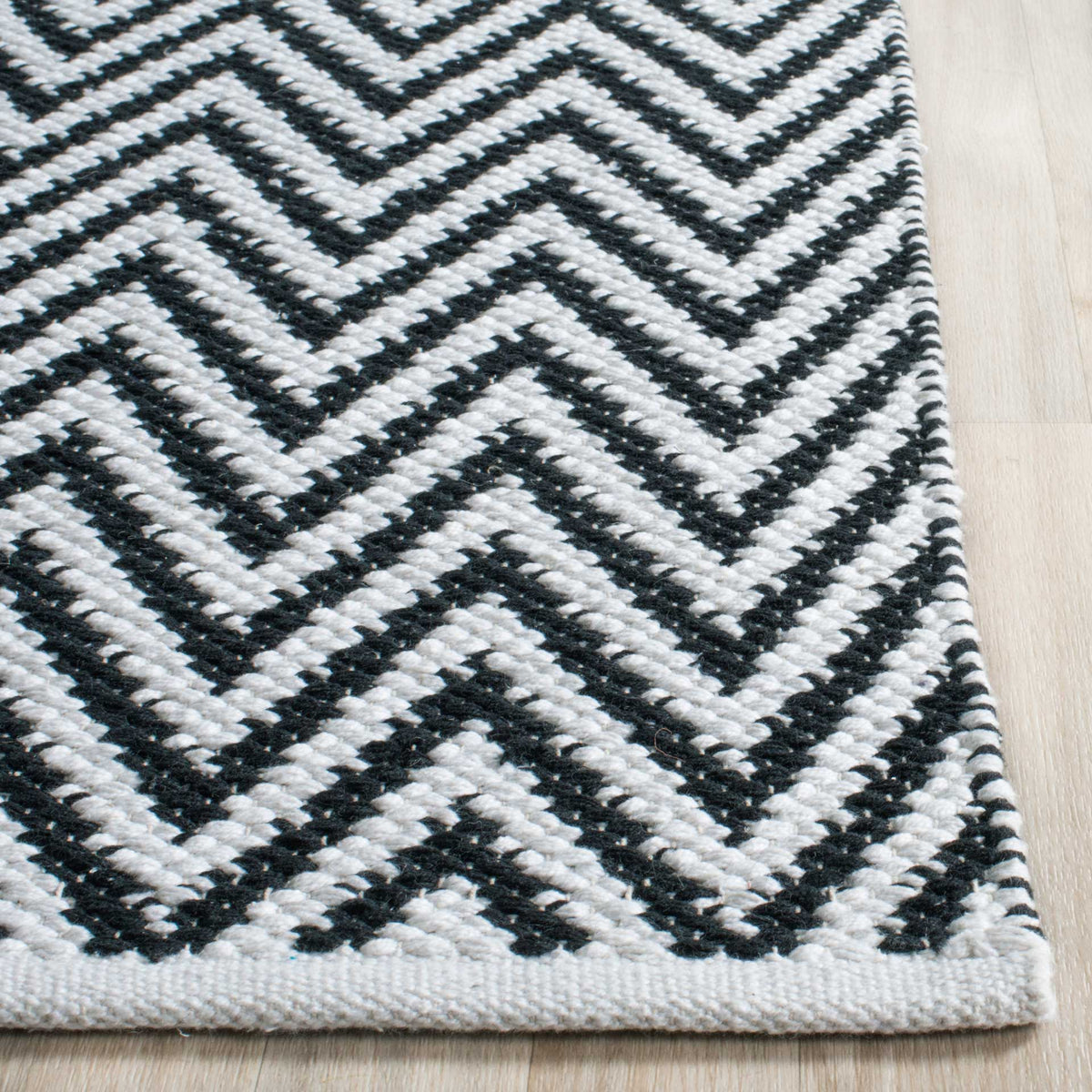 Contrasting black and ivory zigzags meet at a neatly finished cotton corner.