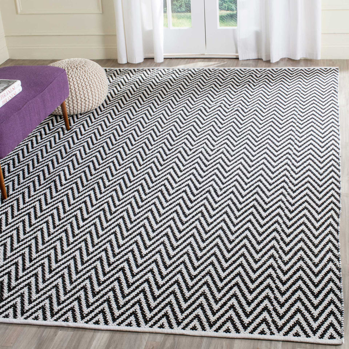 Black and ivory chevrons spread across the floor for a bold, graphic foundation.