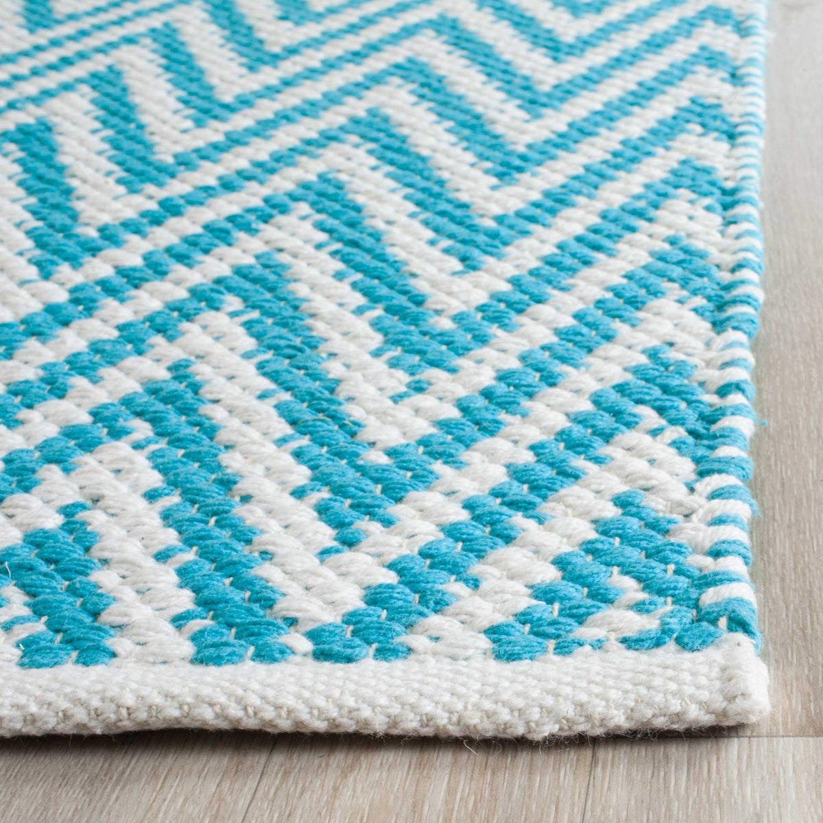 Textured turquoise and ivory cotton chevrons meet a neatly finished ivory border.