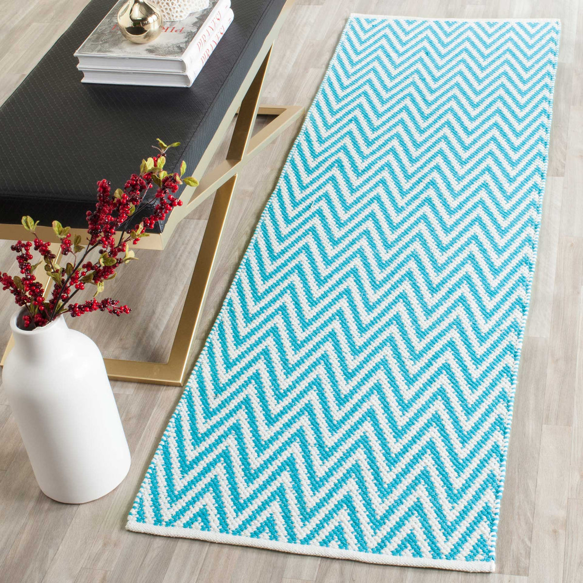 A turquoise and ivory zigzag runner brings fresh color to a light wood floor.