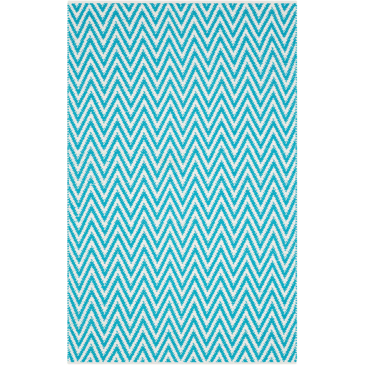 A smaller turquoise and ivory rug brings fresh color and bold chevrons to the floor.