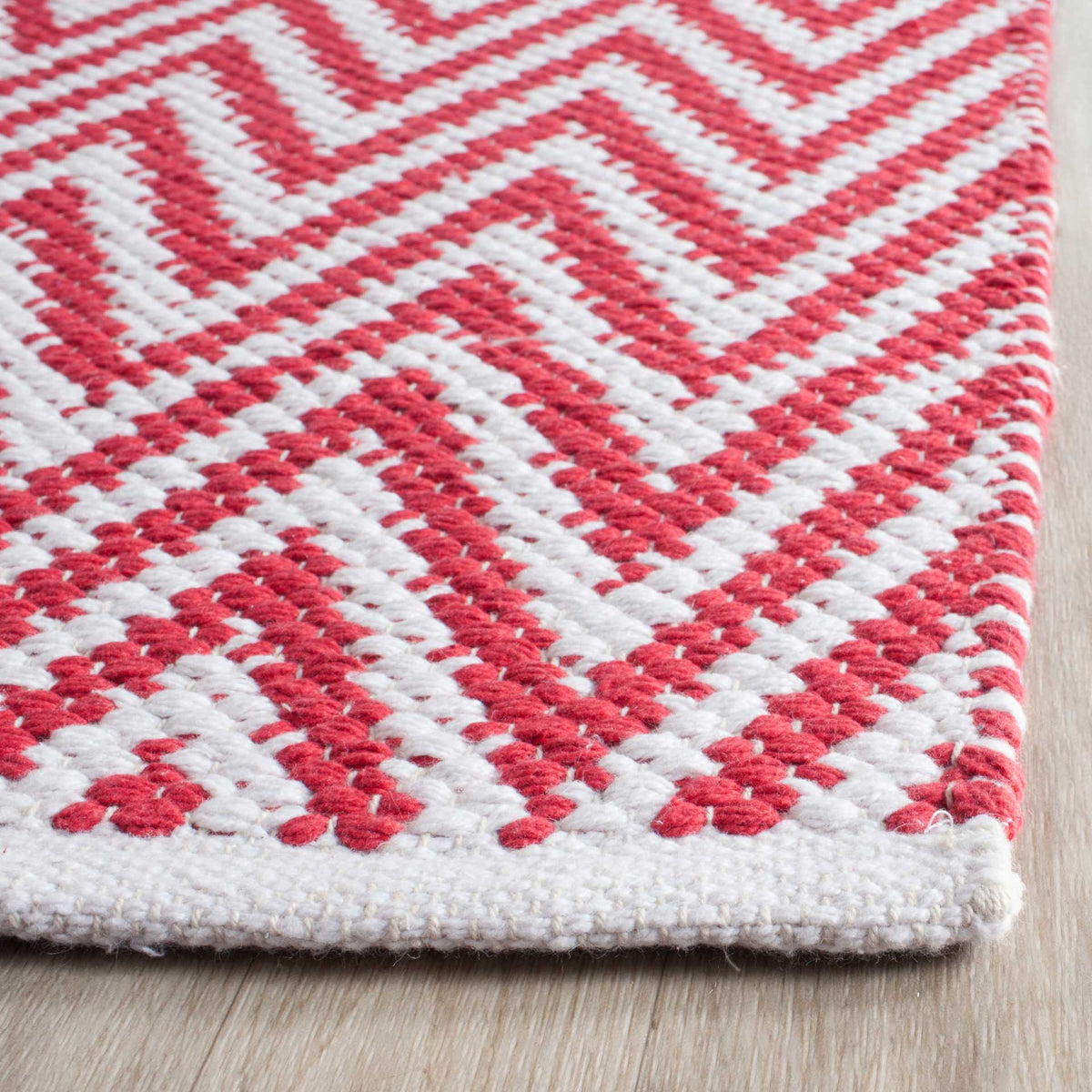 Red and ivory woven cotton forms tactile chevrons with a neat ivory edge.