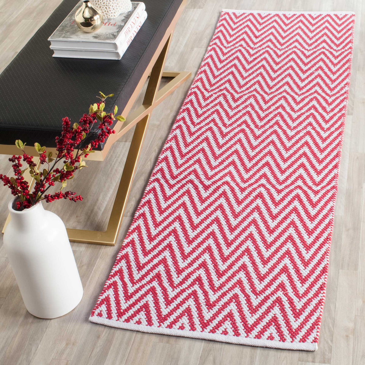 A bright red and ivory zigzag runner adds a lively accent beside modern furnishings.