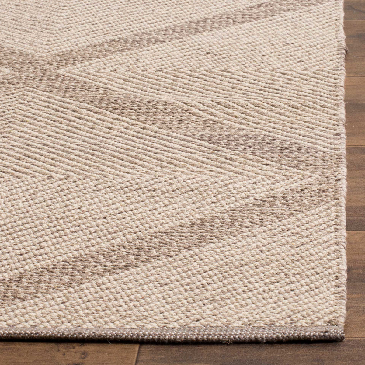 A finished corner highlights the subtle gray diamond lines and textured cotton weave.