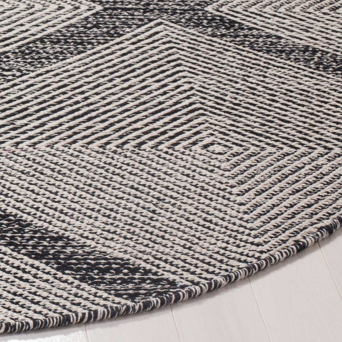 Handwoven cotton reveals finely detailed chevrons and a neatly finished curved edge
