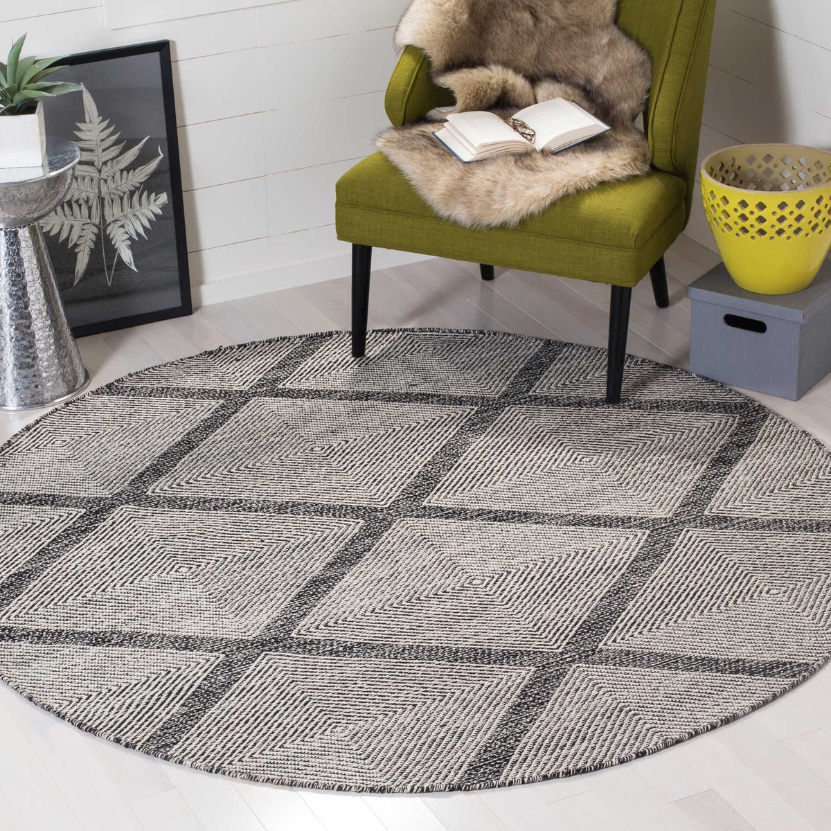 Round black-and-ivory rug anchors a cozy seating area with a striking diamond pattern