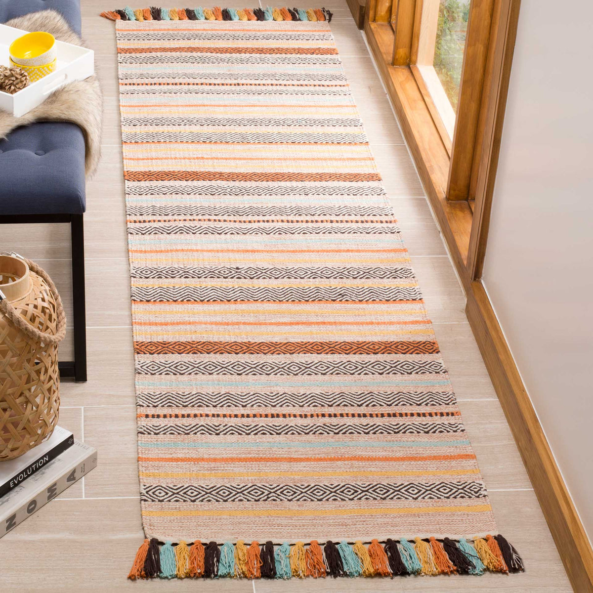 Intricate stripes and bright multicolored fringe bring lively texture to a beige runner