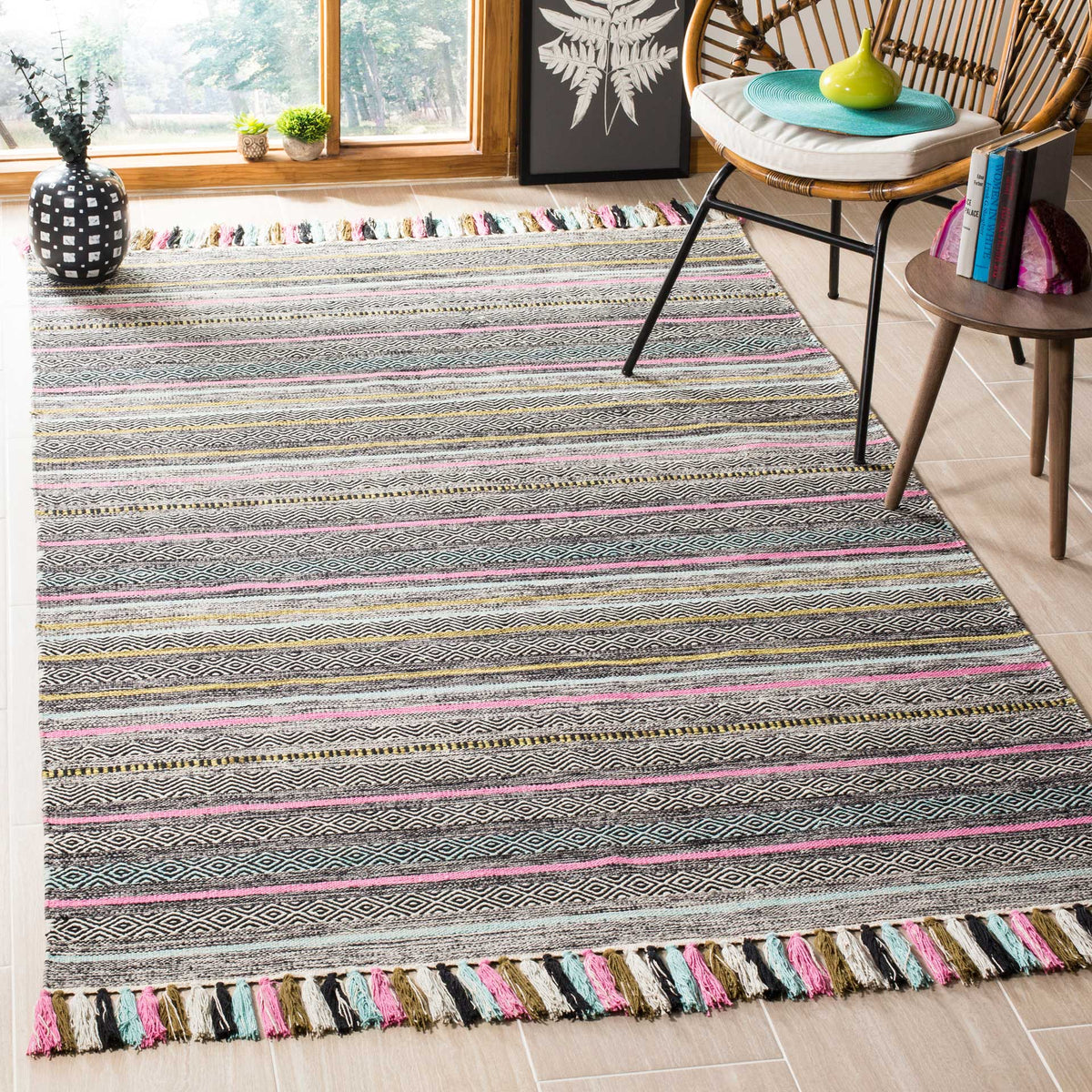 Black and ivory woven stripes enlivened by pink and aqua lines and vibrant tasseled ends.