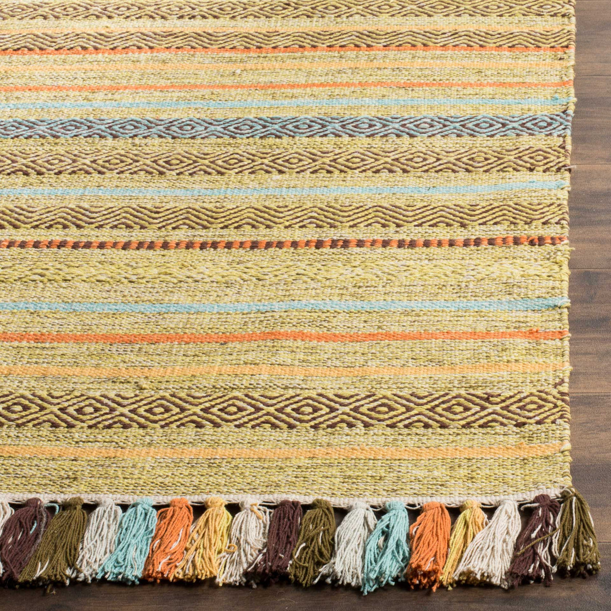 Textured gold weave features blue-green geometric stripes and a richly colored tassel border.
