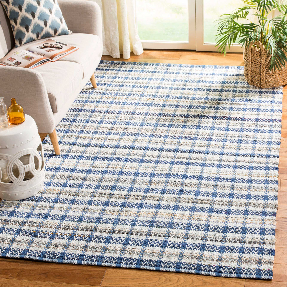 Blue-striped cotton rug grounds a living space with relaxed texture and crisp contrast.