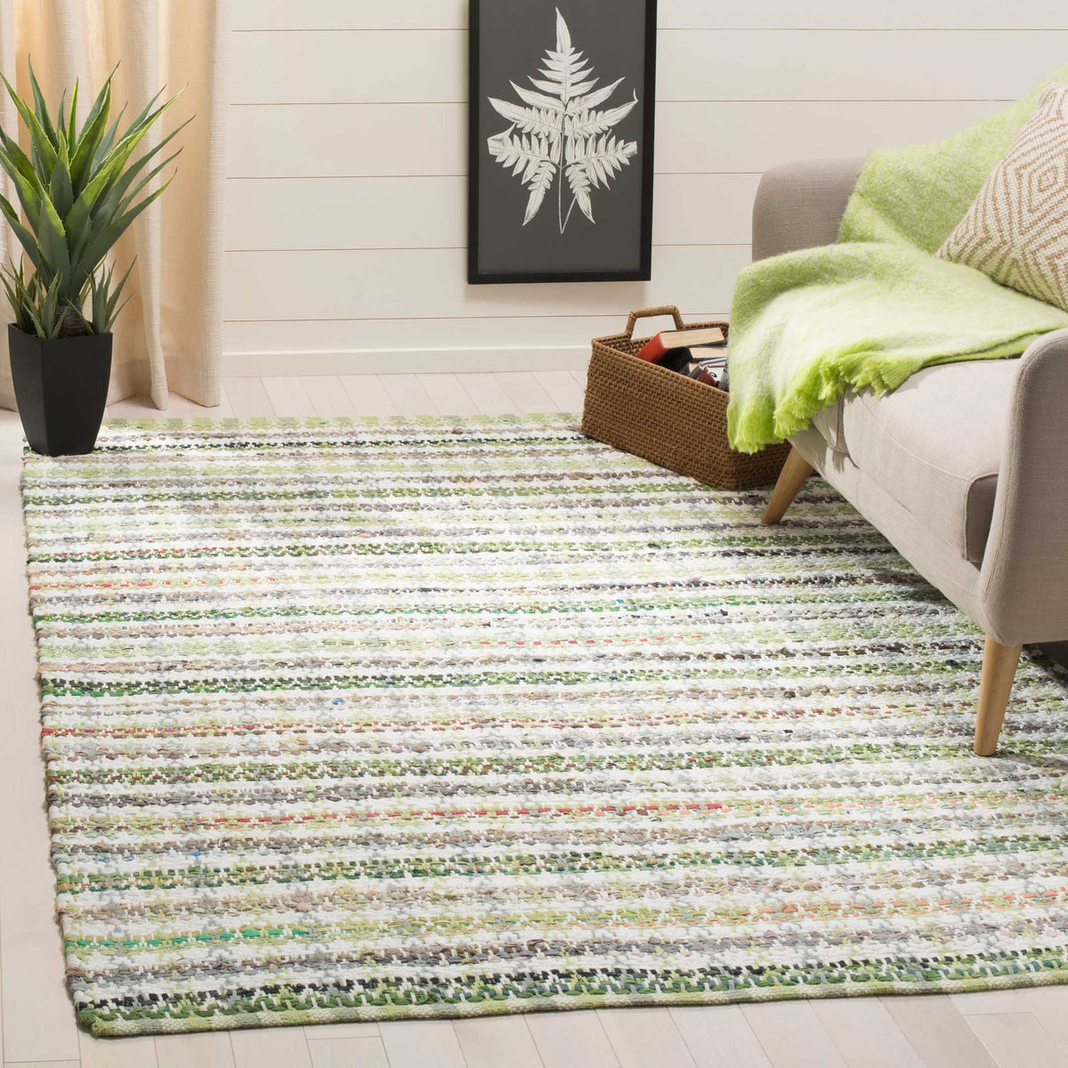 Green striped cotton rug brightens a seating area with an easygoing woven texture.