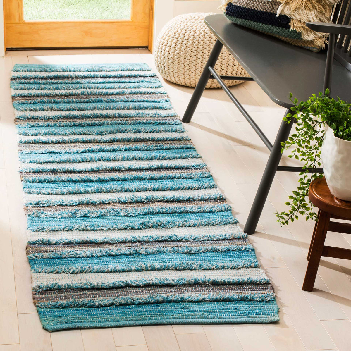 Layered blue and ivory stripes give this textured aqua runner a relaxed feel.