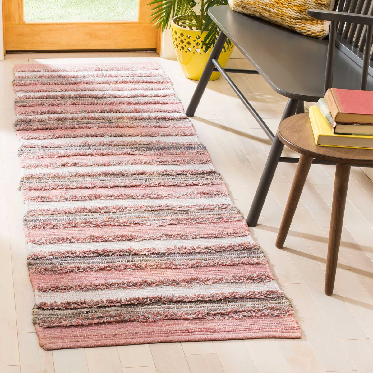 Soft pink bands and varied woven texture bring cheerful color to this striped runner.