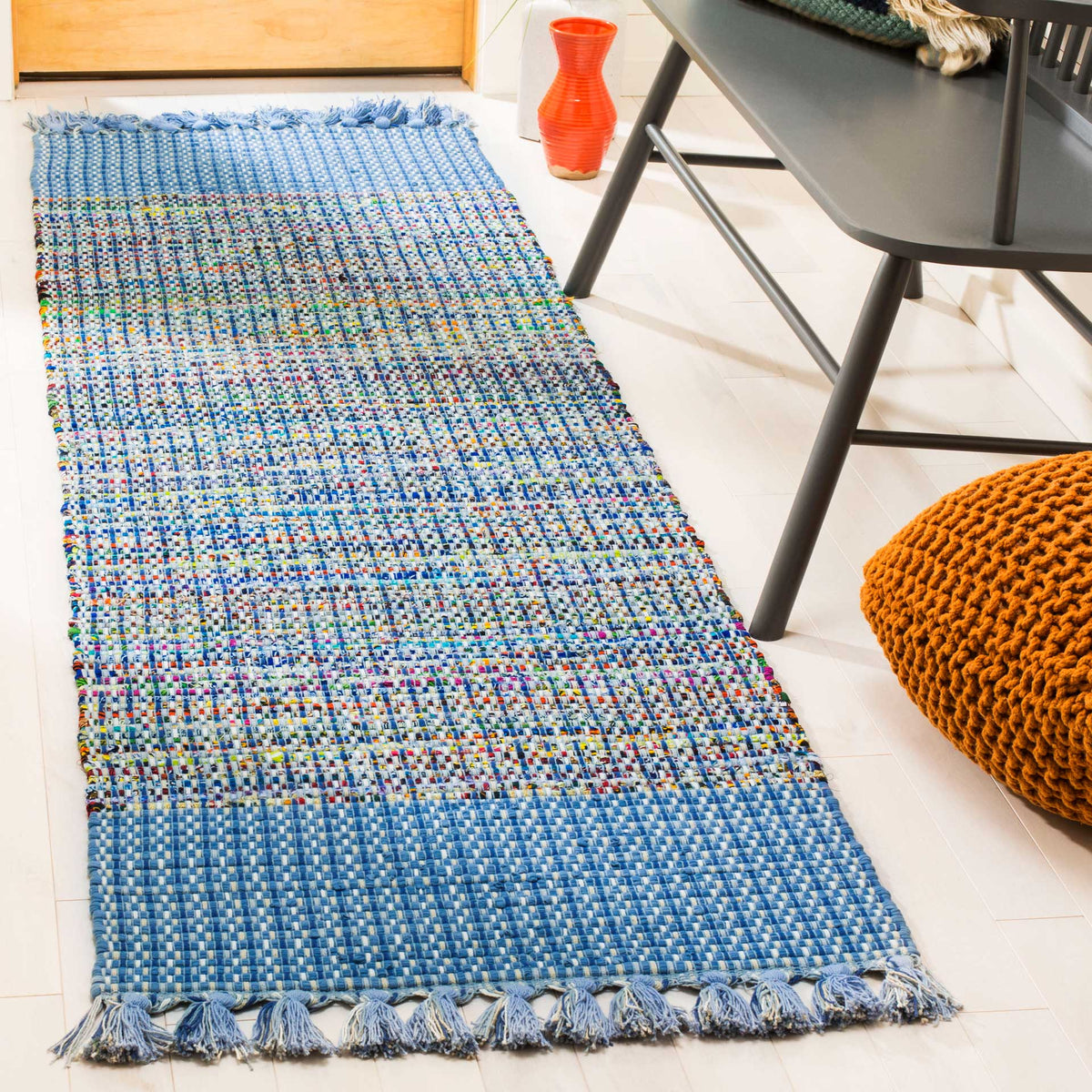 Bright blue end panels frame a speckled multicolored weave beside a bench