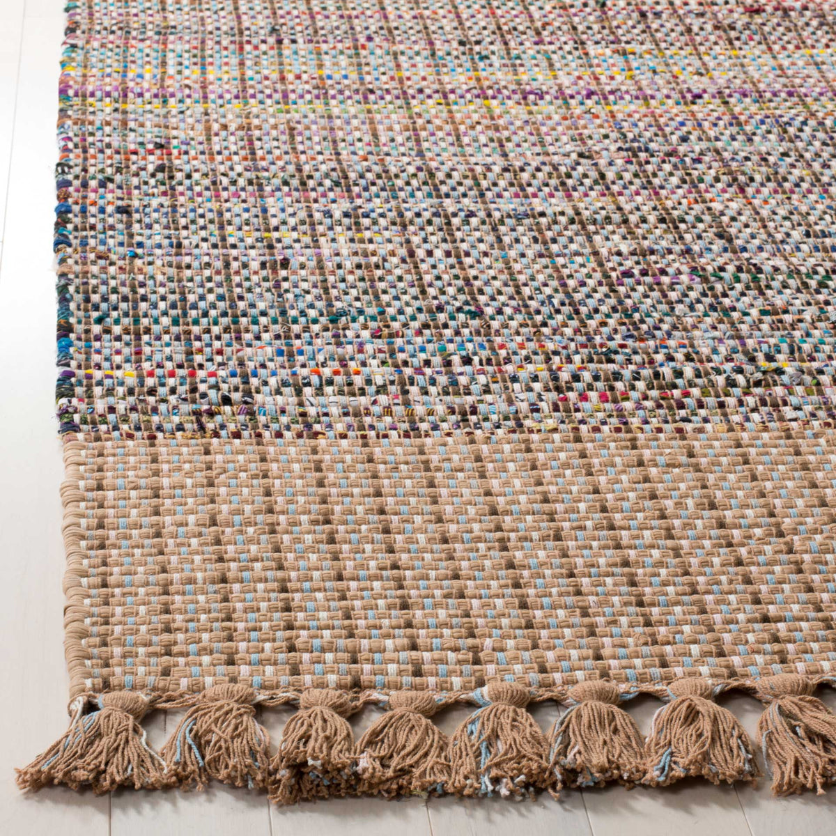 Natural beige cotton border meets a richly colored weave and tassel fringe