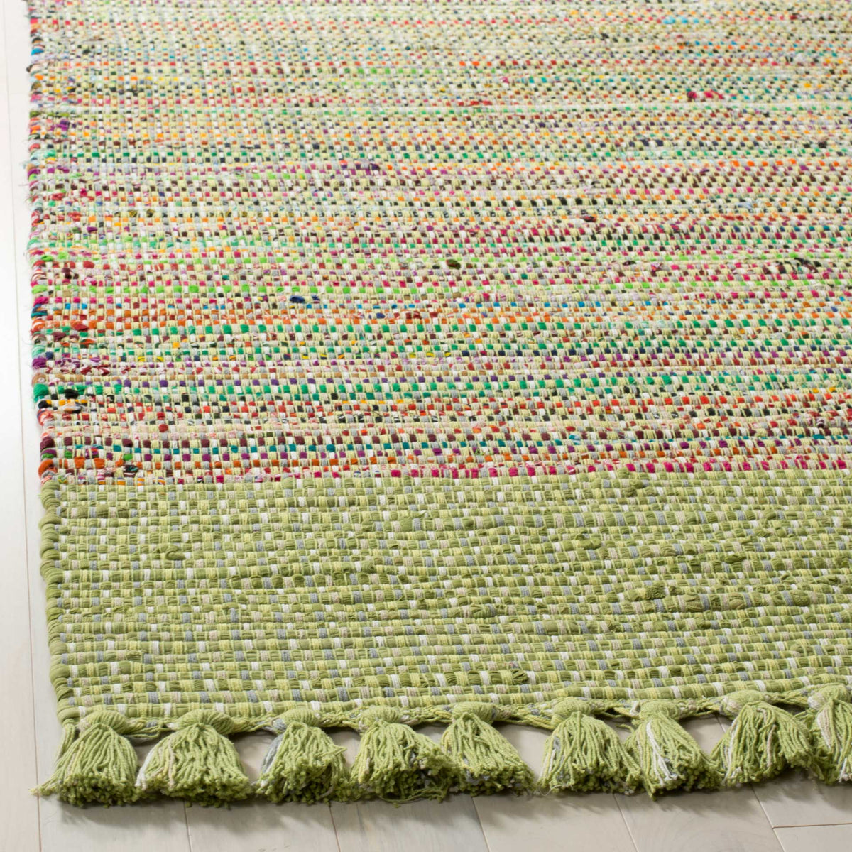 Pale green cotton border and tasseled fringe complement a richly colored weave