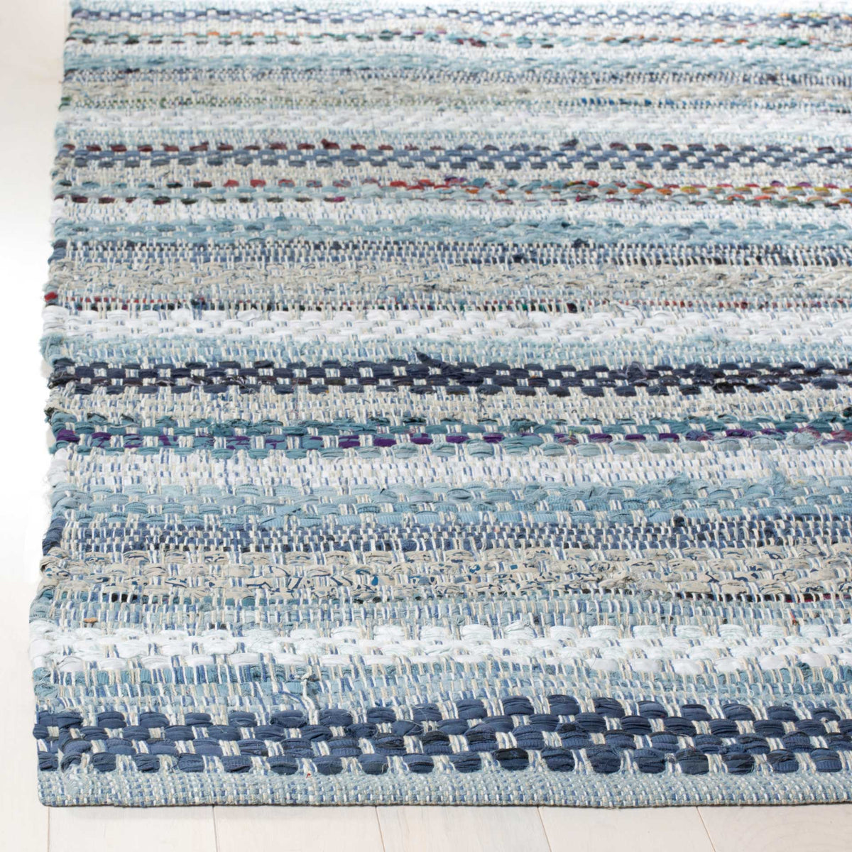 Interlaced blue and cream cotton yarns create rich texture along this rug's finished corner.