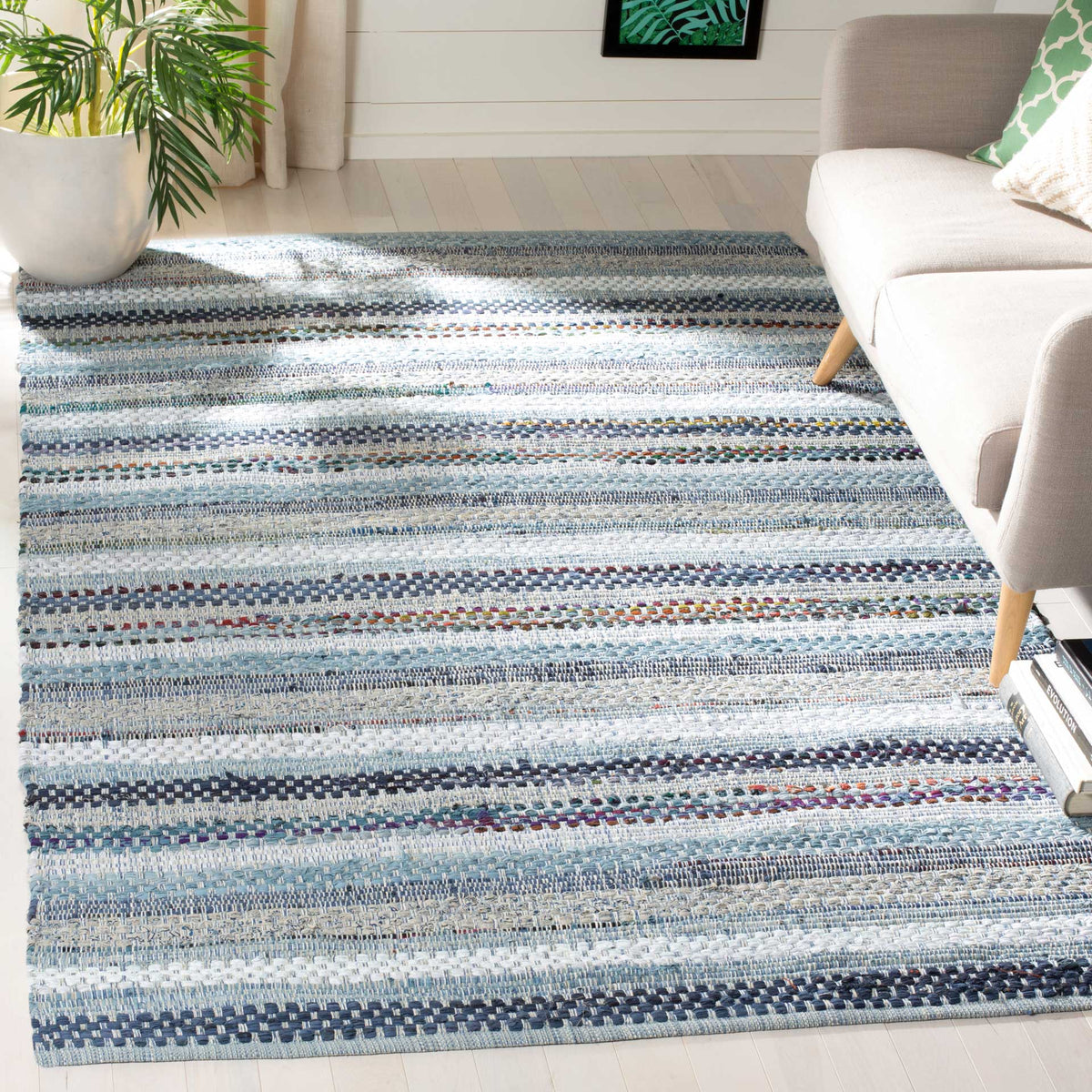Blue and ivory woven stripes bring a calm, textured foundation to a bright seating area.