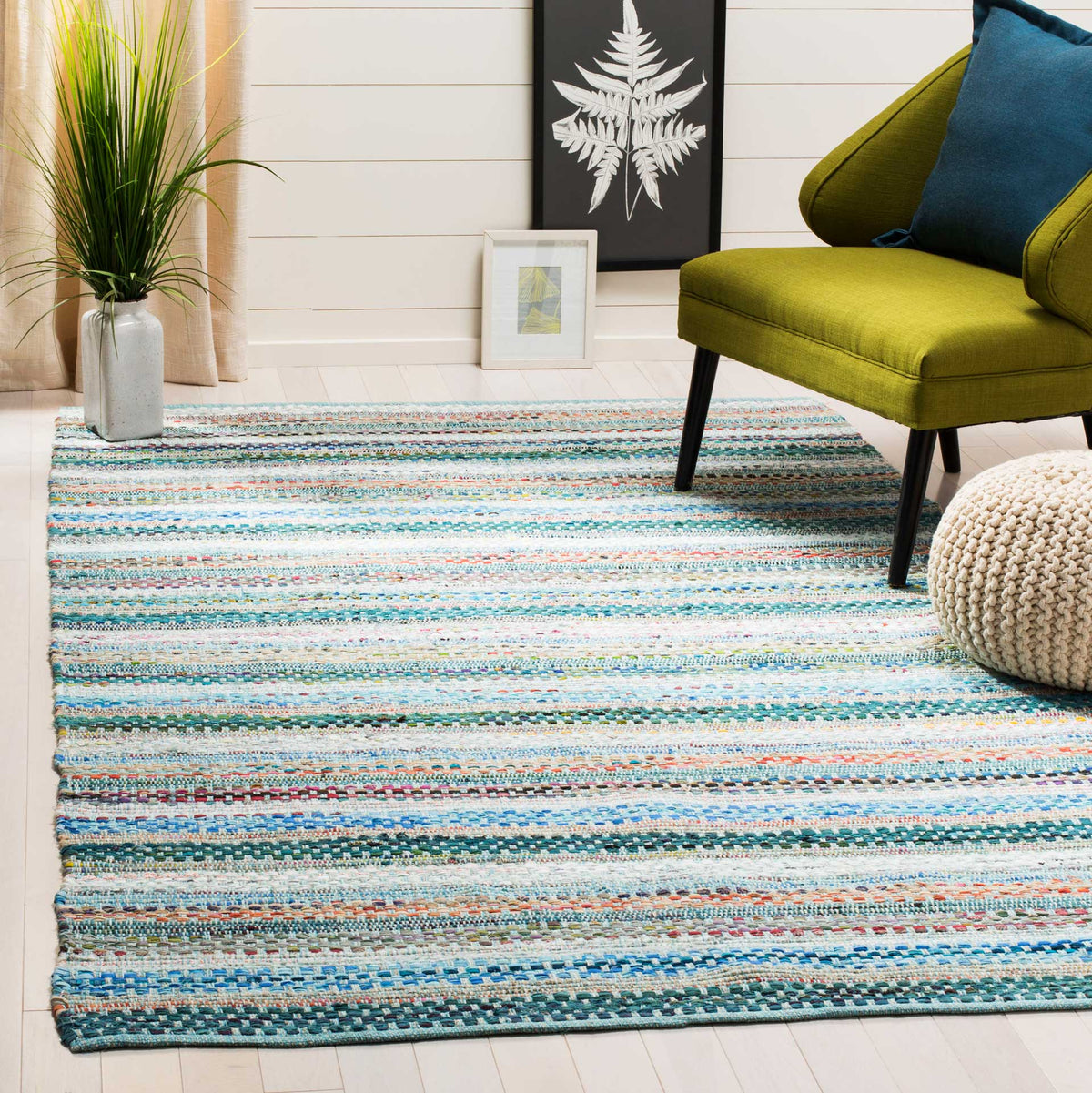 Aqua and multicolored stripes add easygoing color and woven texture beneath a lounge chair.