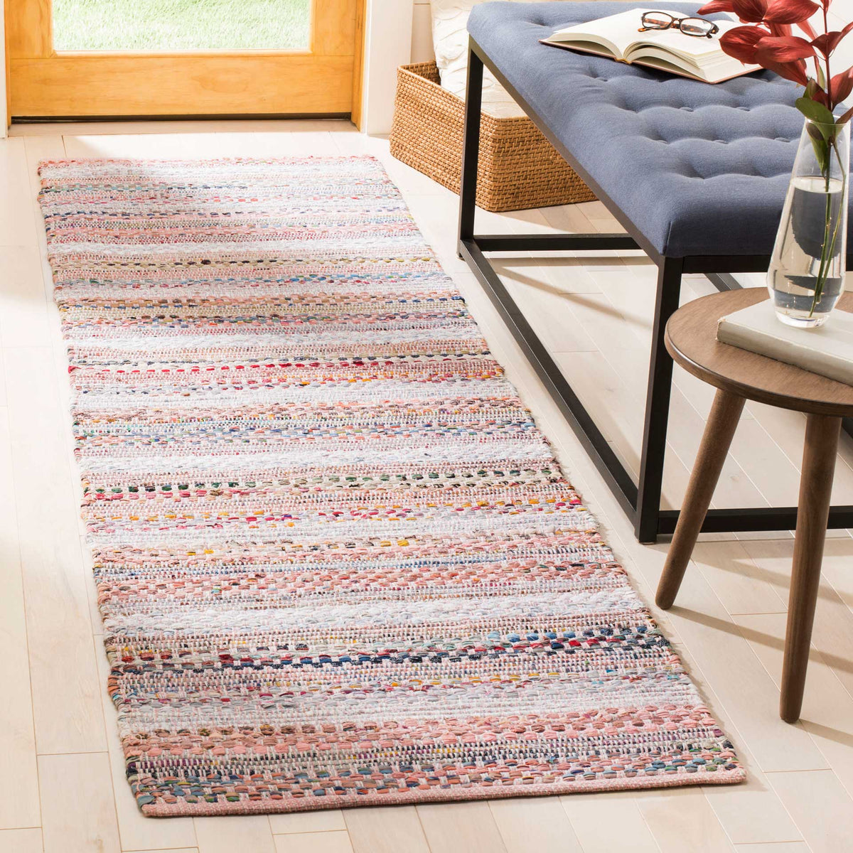 Pink and coral stripes bring a cheerful, textured accent to a sunlit entryway