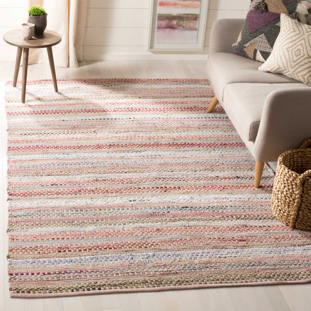 Soft rose and cream stripes bring gentle color and a tactile handwoven feel to a seating area.